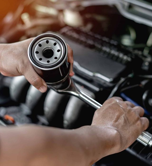 Close,Up,Oil,Filter,Of,Car,And,Wrench,In,Hand